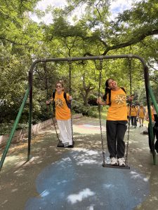 eye YPAG members on swings in the park on the route