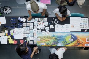 Arial view of young people stood by table with lots of activities laid out